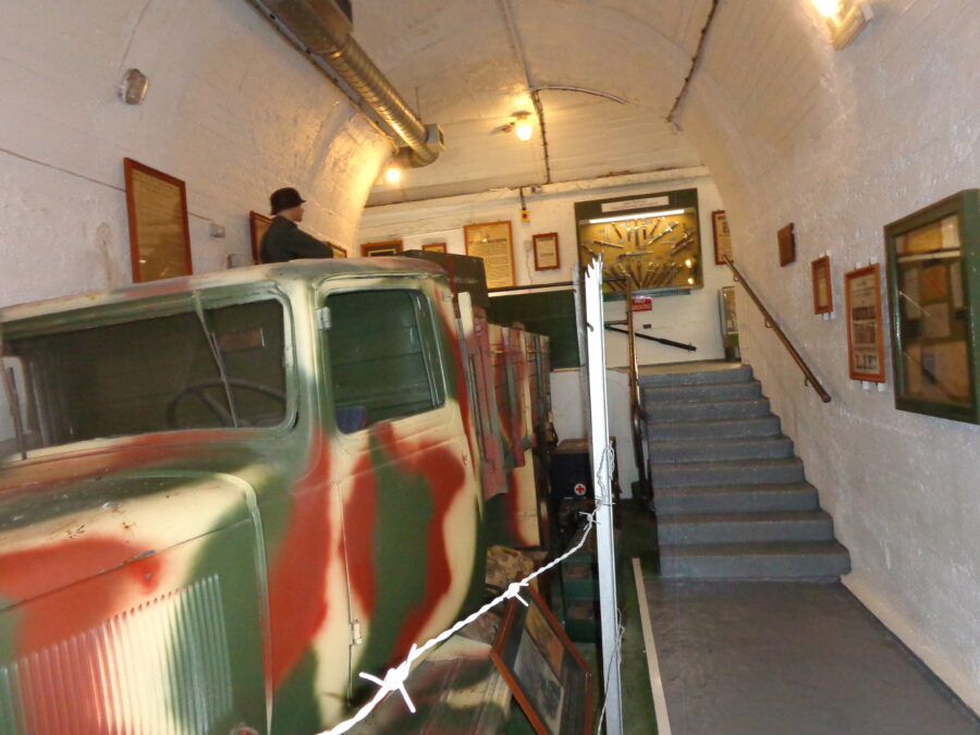A German military truck painted in camouflage colours inside La Valette Underground Military Museum.