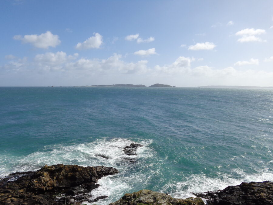 Another view across the sea from Castle Cornet. Herm can again be seen to the left. To the right the more distant island of Sark is also visible. Sark is about 7 miles (11 km) away. Sark is self-governing with a population of around 560. It has an area of 2.10 square miles (5.45 sq. km).