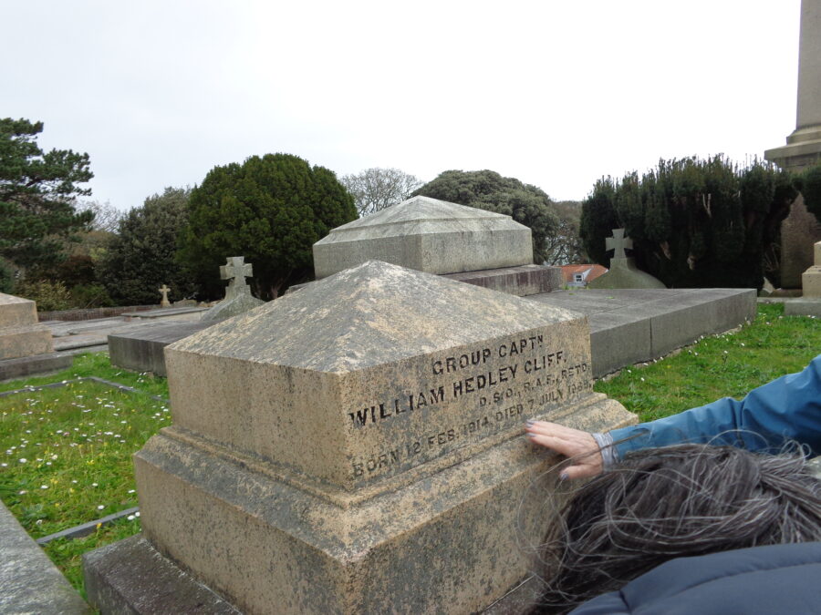 A light-coloured gravestone with a square-profile and pyramid-shaped top. The inscription reads: "GROUP CAPTN. WILLIAM HEDLEY CLIFF, D.S.O., R.A.F., RETD., BORN 12 FEB. 1914, DIED 7 JULY 1989." Captain William Hedley Cliff won the DSO for action during World War II. In 1958 he bought the lease to the small Channel Island of Jethou and opened it as a resort with around 5,000 visitors a year. At that time the island printed its own postage stamps which were sold to tourists. He sold the island five years later.