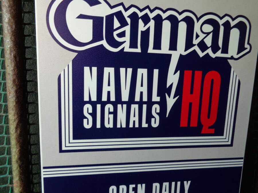 A modern logo sign that reads "German Naval Signals HQ".