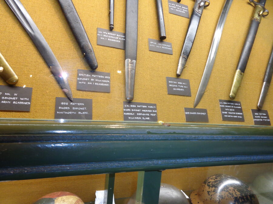 A case containing a collection of swords and daggers. These are British military items mostly dating from the second half of the 19th century.