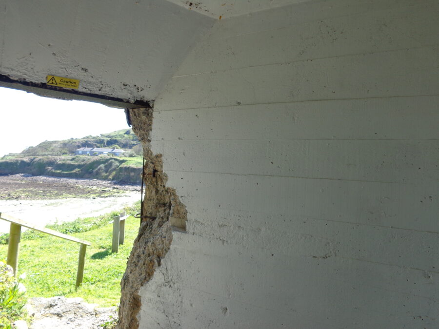 Inside a concrete gun emplacement facing Longis Bay and close to the Roman fort. Built by the German military during World War Two.