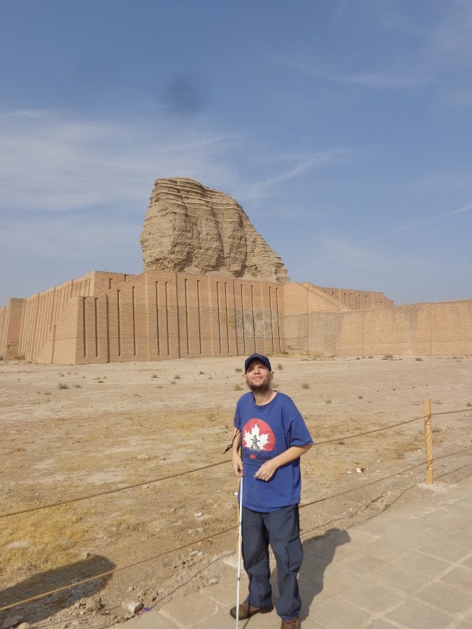 Tony with the Ziggurat of Dur-Kurigalzu in the background. The base of the ziggurat is roughly square-shaped measuring 69 metres by 67 metres. It rises to 52 metres in height. The lower level of the Ziggurat has been heavily restored while the upper part still has its original sun-dried square bricks which are today heavily eroded and irregular in shape. From a distance the upper part now resembles a natural rock formation. A raised walkway can be seen connecting with stairways leading up to the Ziggurat's first level. The steps have been restored using the same tan-coloured bricks as used originally. Many of the original bricks bear a dedication by king Kurigalzu of the temple to the god Enlil.