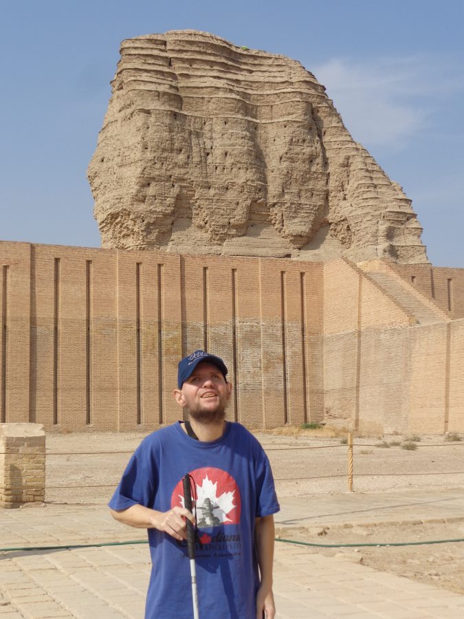 Tony with the Ziggurat standing prominently in the background. The foreground is paved with small square stone slabs. Tony is near the temple complex located close to the Ziggurat.