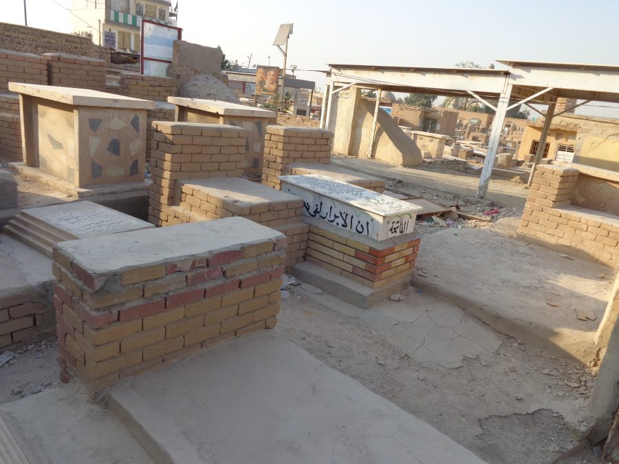 Shot across another part of Wadi-us-Salaam cemetery. More rows of tightly packed tombs. The ground in-between is dry and sandy.