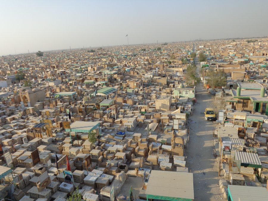 Looking down at Wadi-us-Salaam cemetery spread out below. The view extends to the horizon and it is difficult to determine where the cemetery ends and the buildings of the city itself begin. The cemetery covers 2.32 square miles (or 6.01 square km) and contains more than 6 million bodies.