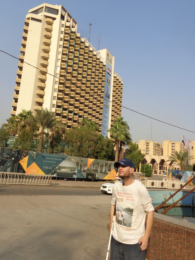 Tony next to the magic carpet fountain and sculpture. The large, multi-storey building in the background is the 16-storey International Palestine Hotel. It was built in 1982 by the Iraqi government. This was one of the hotels used by foreign journalists during the 1991 Gulf War and the 2003 invasion of Iraq. During the 2003 invasion of Baghdad an American tank fired a shell at the hotel killing two journalists: these were Reuters cameraman Taras Protsyuk and José Couso of Telecinco Spanish television. The Americans wrongly believed they were firing on Iraqi troops.
